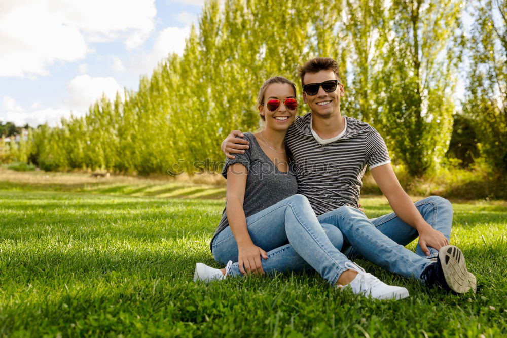 Similar – Beautiful young couple laying on grass in an urban park