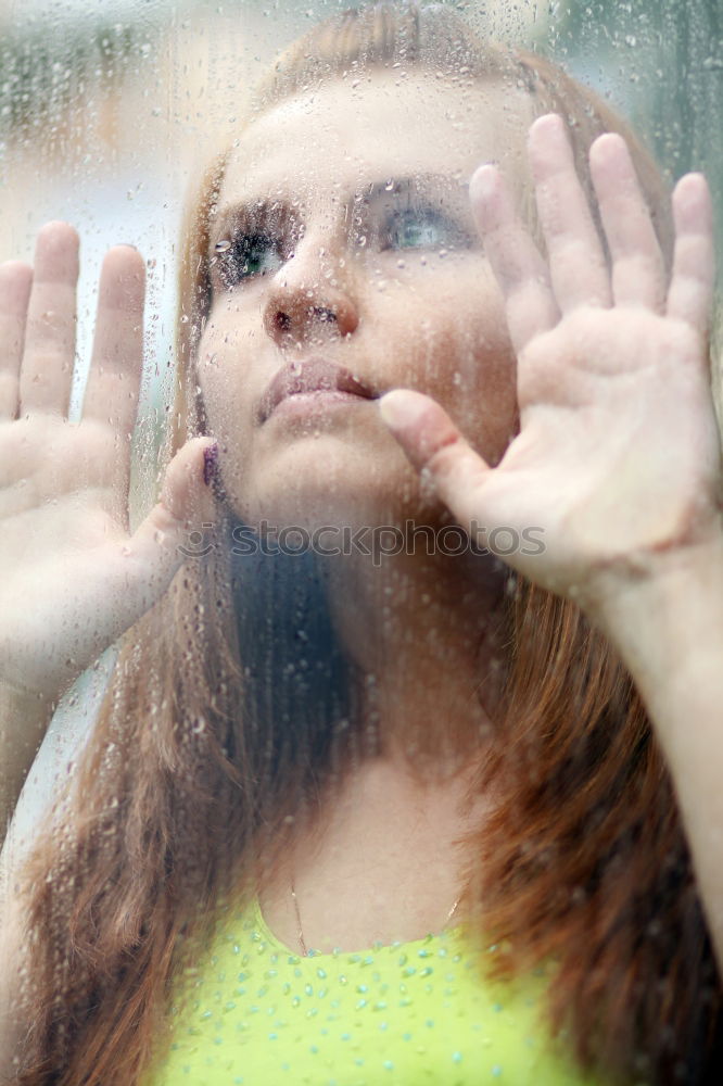 Similar – young, redheaded woman with curls looks out of the balcony window