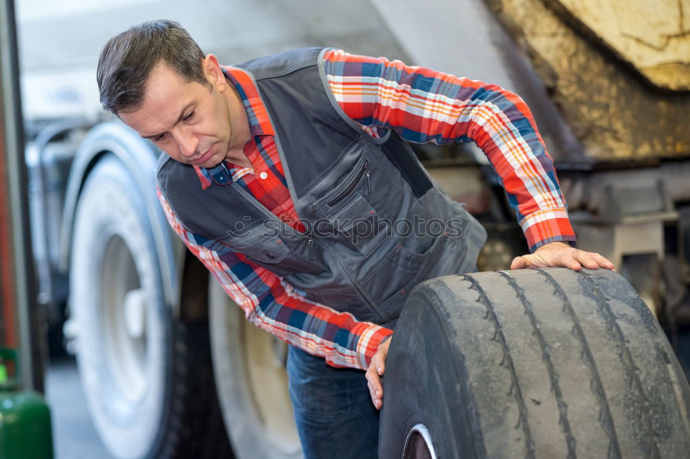 Similar – Image, Stock Photo Mechanic checking wheel of a customized motorcycle