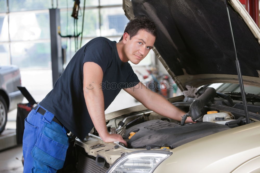 Similar – Professional Mechanic Repairing Car.