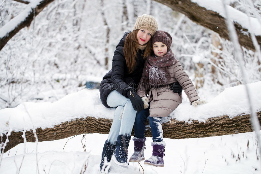 Similar – Teenage girl pulling sled with her little sister through forest