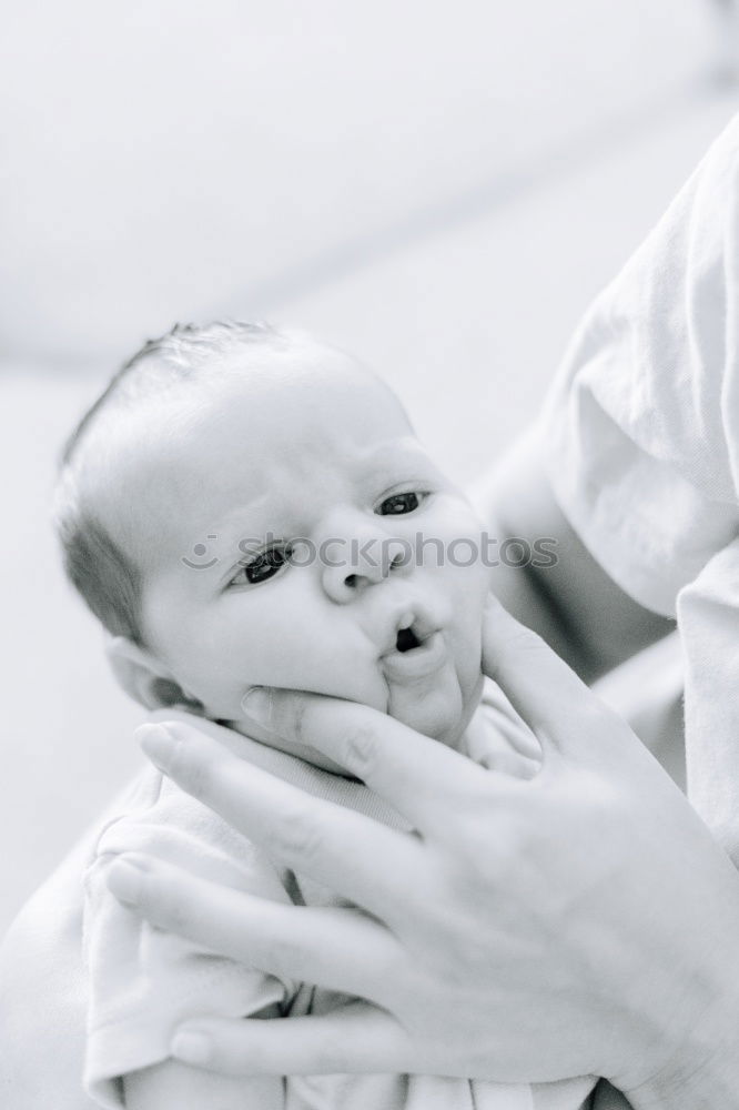 Person touching hand of baby