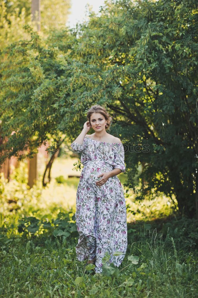 Similar – Young woman in a summer dress standing in an asparagus field