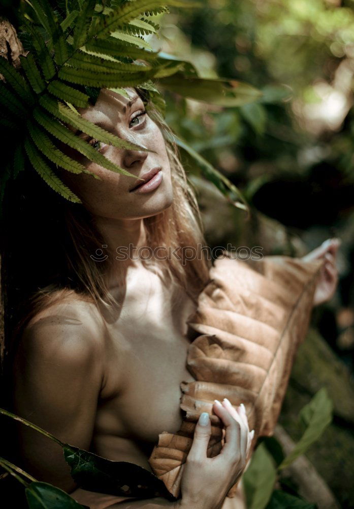 Similar – Image, Stock Photo Young tattooed woman with turquoise hair sits barefoot in beach forest leaning against tree and smiles at camera