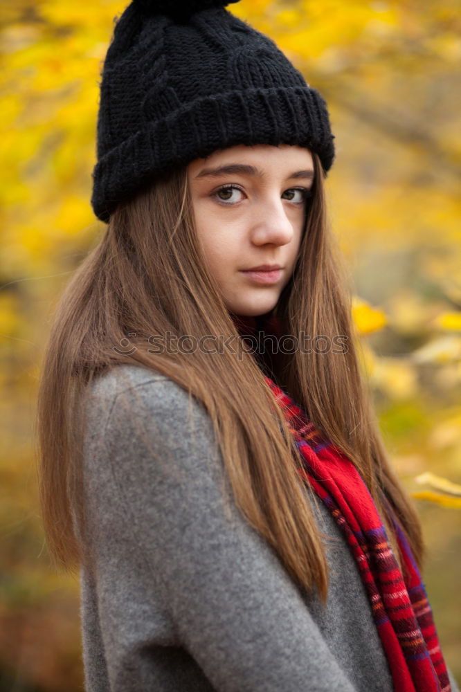 Similar – Young woman sitting on the street