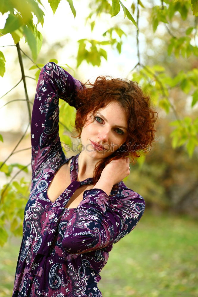 Similar – Relaxed girl lying on the field with long curly hair