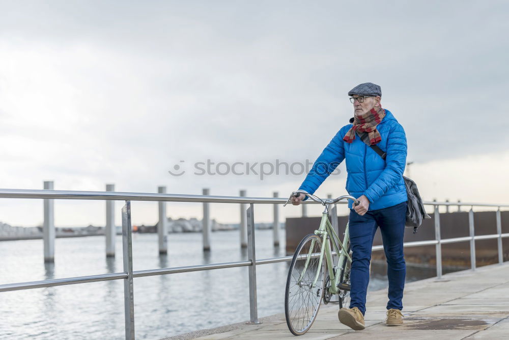 Similar – Image, Stock Photo Portrait senior man walking with his bicycle next to the sea