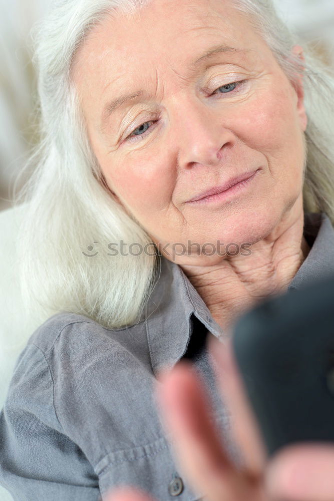 Similar – senior woman using smartphone