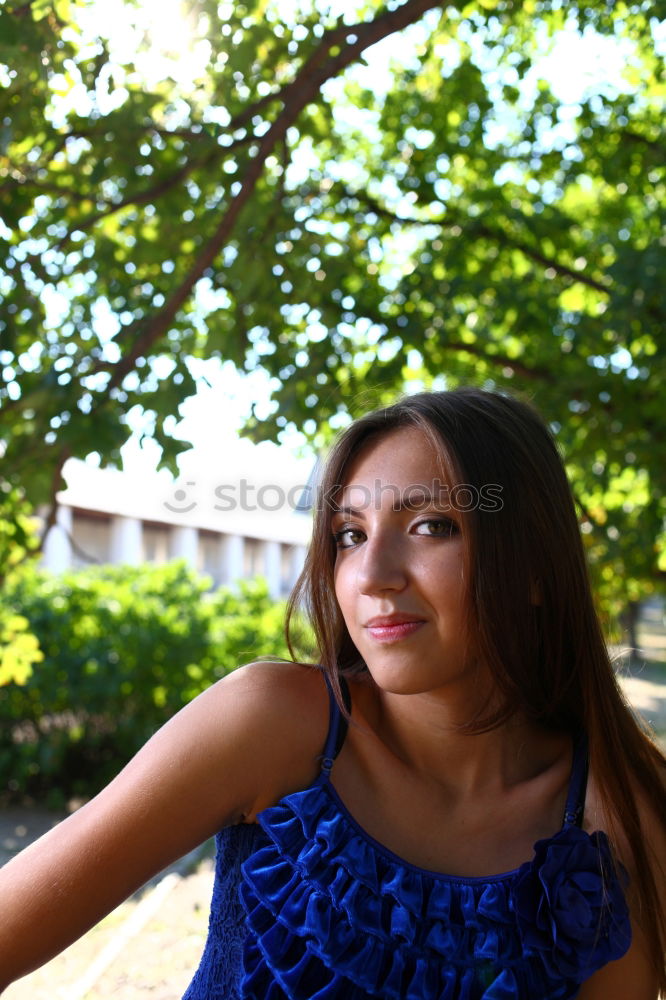 Similar – A young woman sitting on a garden bench