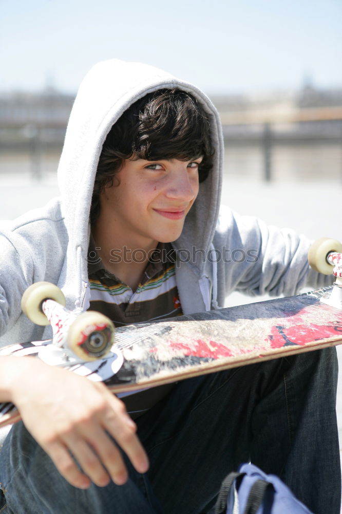 Similar – Man with tattoos holding skateboard at shore. Back view.