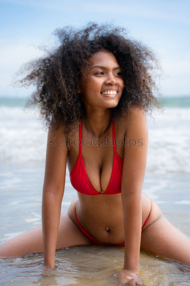 Beautiful young woman posing on the sand in a desert dunes