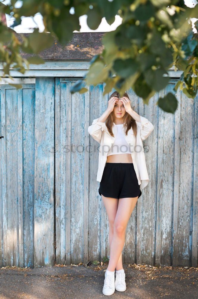 Similar – Happy young blond woman next to urban door.