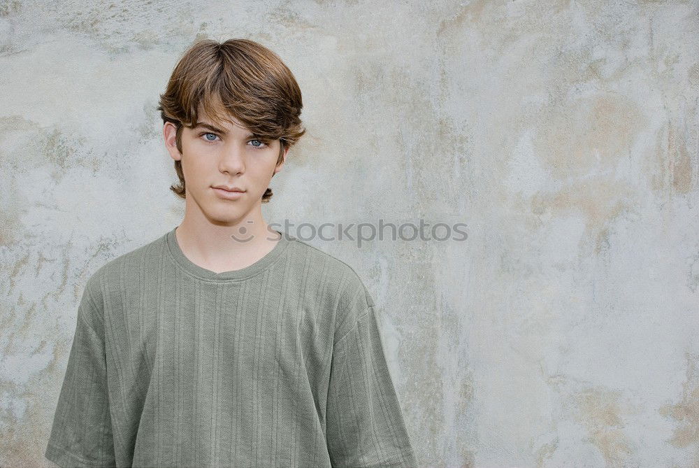 Similar – Portrait of a teenager with hoodie, in front of a red brick wall