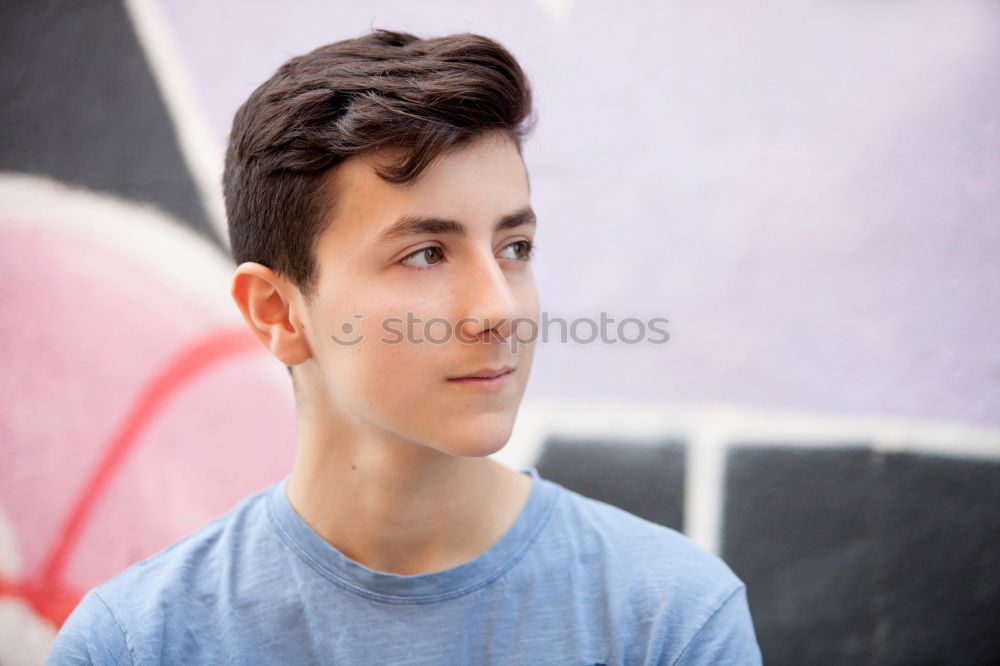 Similar – Portrait of a teenager with hoodie, in front of a red brick wall