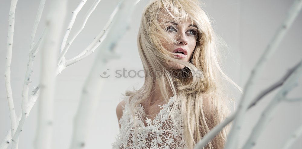 Similar – Young woman observing weird flowers