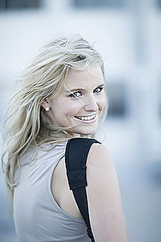 Similar – Image, Stock Photo Smiling woman in yellow dress standing and chatting on her smart phone in front of graffiti painted on corrugated iron