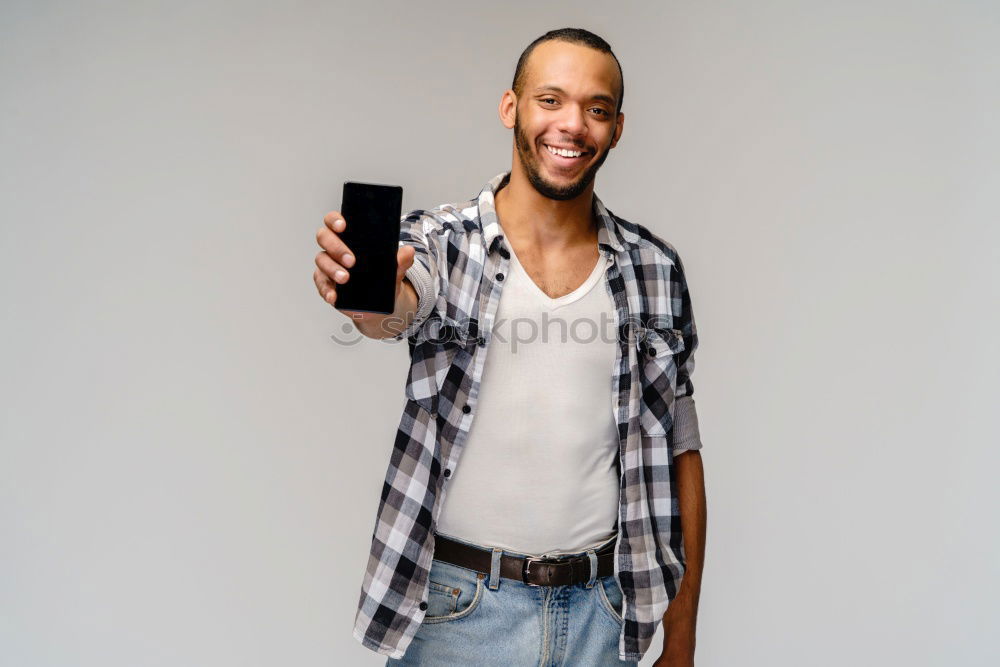 Similar – Image, Stock Photo Black young man with a smartphone in his hand