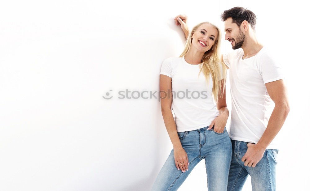 Similar – Side view Happy couple in love jumping against grey wall.