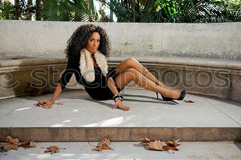 Similar – Happy young black woman sitting surrounded by flowers