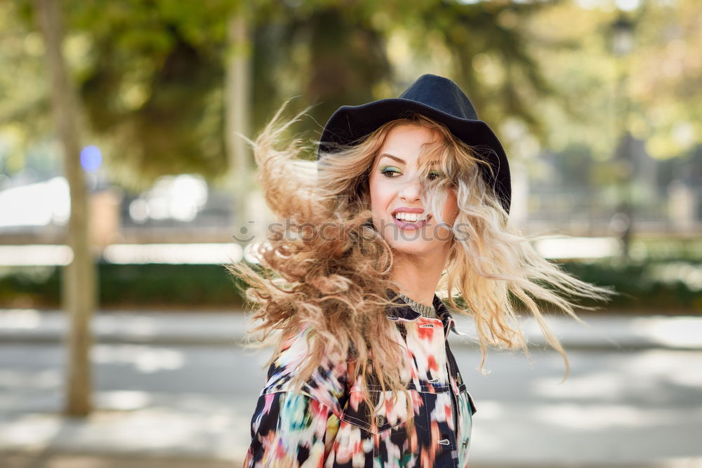 Similar – Image, Stock Photo Smiling blond woman with hat in urban background