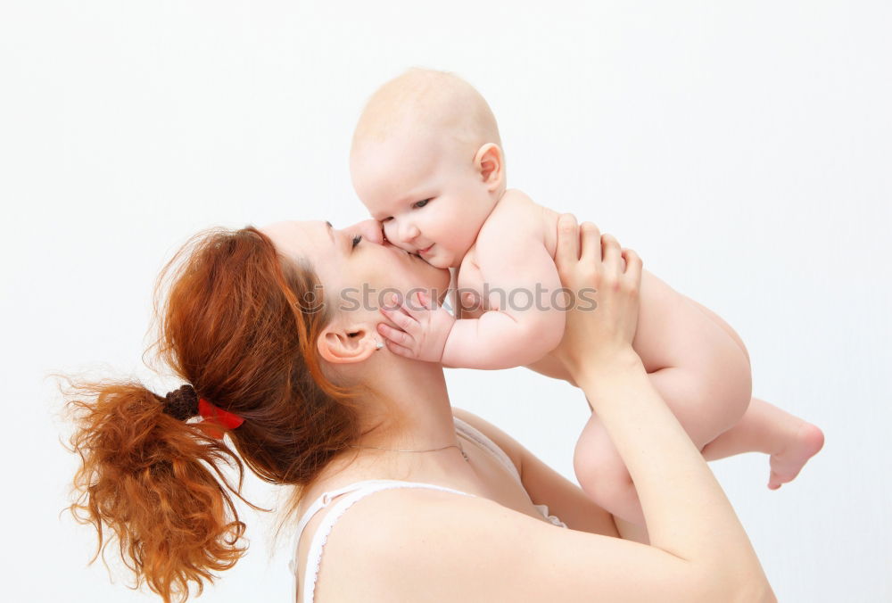 Similar – happy young mother and her baby boy lying on bed and smiling