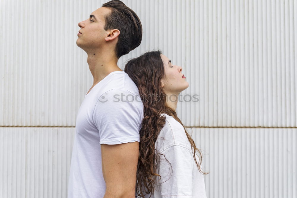 Similar – Side view Happy couple in love jumping against grey wall.