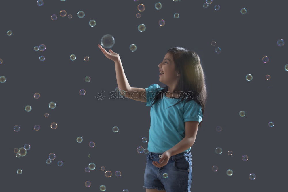 Child stands in a shower of confetti