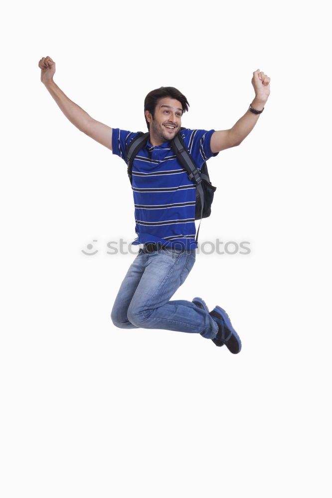 Similar – young man jumps into the air with three-coloured shadow