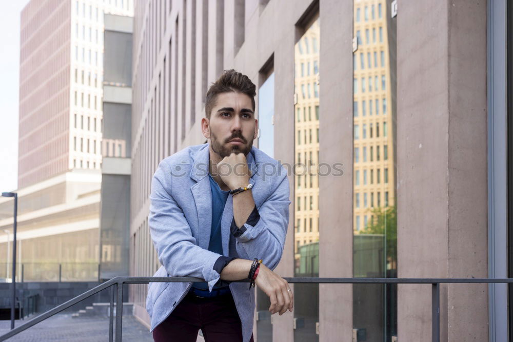 Similar – Young bearded man, model of fashion, in urban background wearing casual clothes while leaning on a wall and looking aside