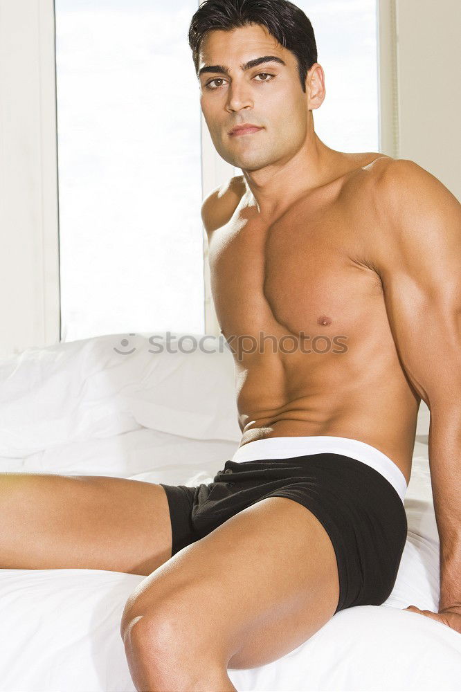 Similar – Young sexy pensive man sitting on bed