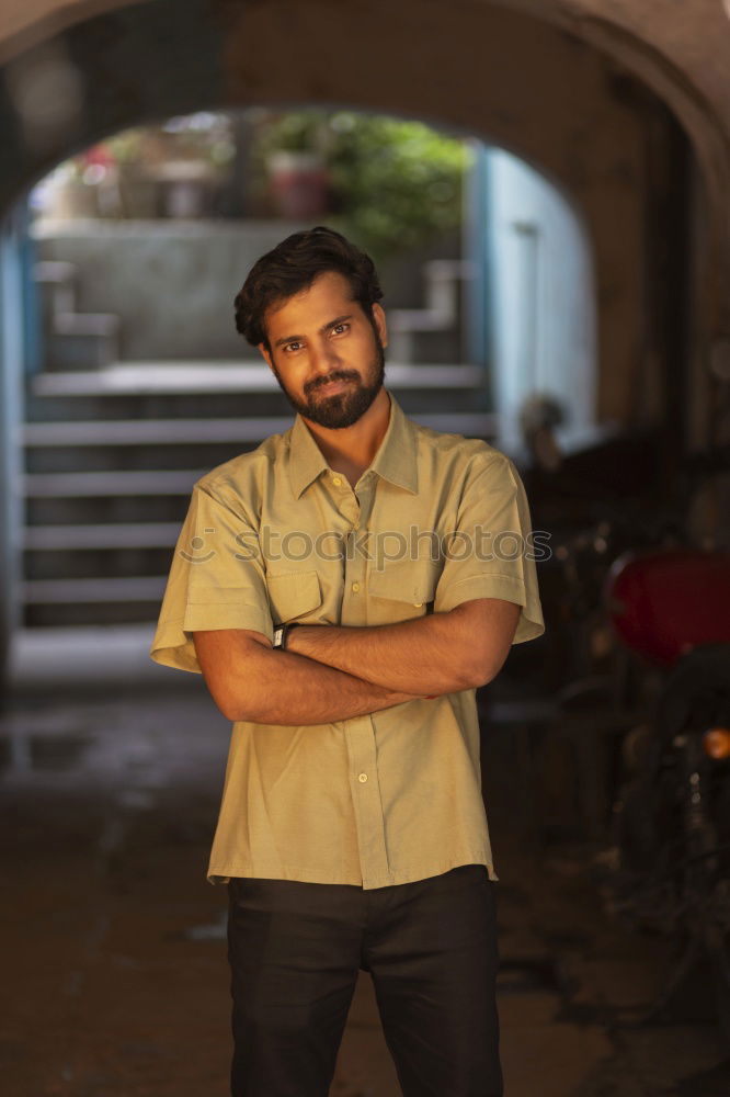 Young smiling man wearing modern shirt in the street