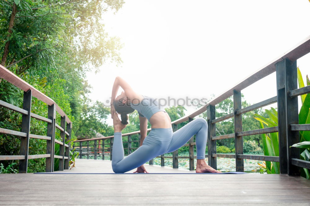 Similar – Image, Stock Photo Young woman doing yoga on wooden road in nature