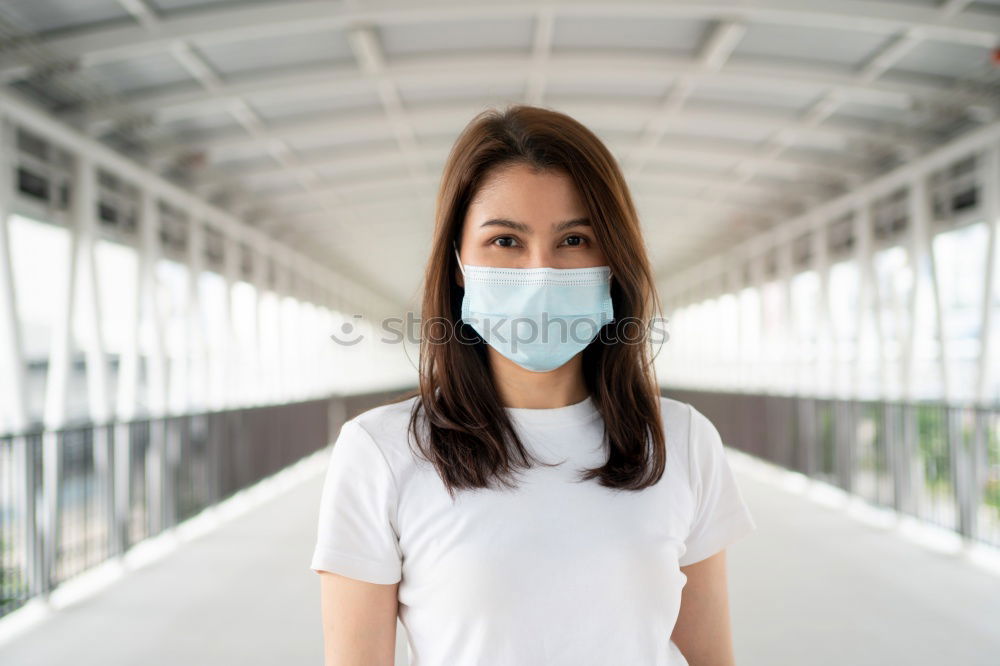 Similar – Female teenager in protective mask standing near electric scooter