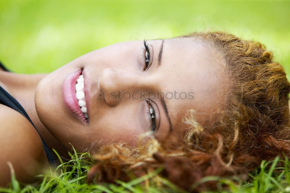 Similar – Black woman with afro hairstyle smiling in urban park.