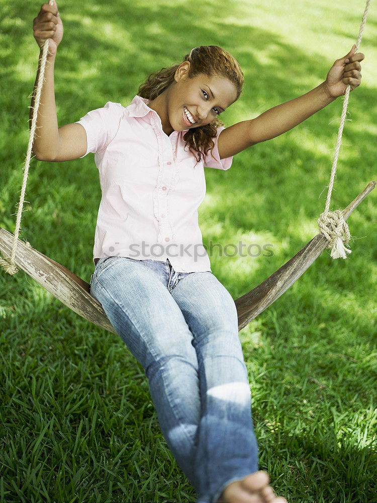 Similar – Jule Young woman with dreads is sitting on a bench in the green.