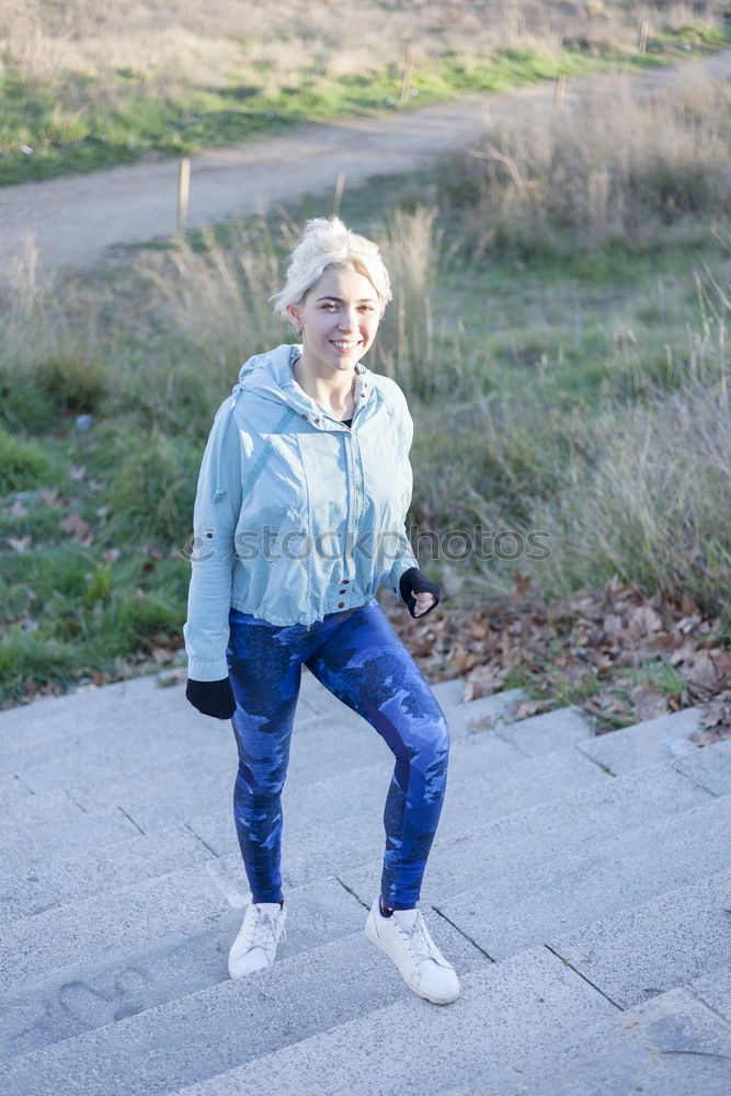 Similar – Happy young blond woman next to urban door.