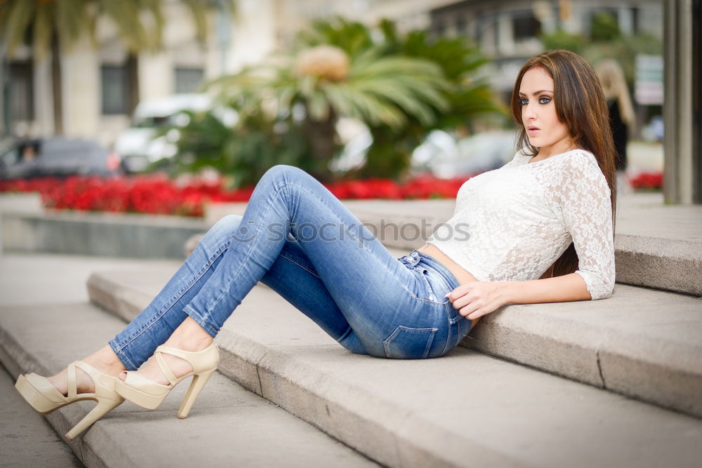 Similar – Image, Stock Photo Smiling young woman relaxing on sidewalk