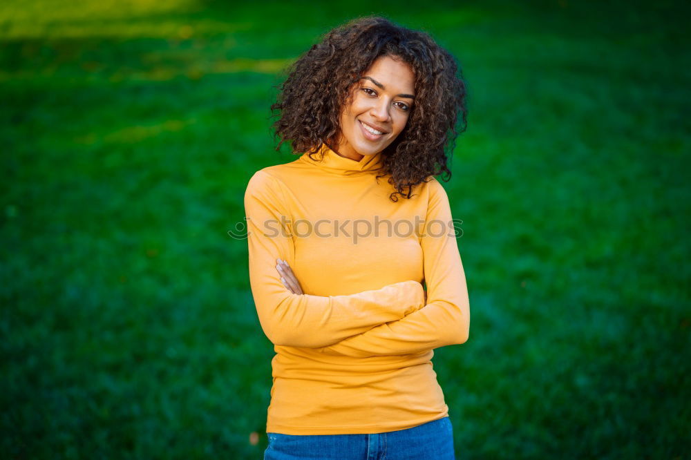 Similar – Young black woman with afro hairstyle smiling in urban park