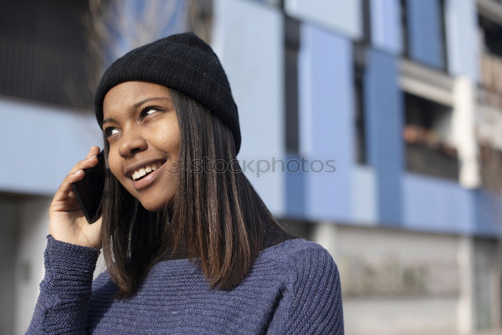 Similar – Happy woman with hat in city street, while using technology