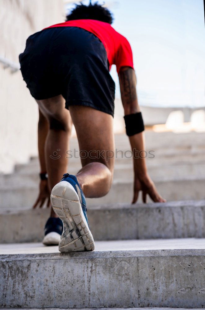 Similar – Image, Stock Photo Close-up shot of man tying running shoes with foot on the bench. Getting ready before jogging. Going in for sports, healthy lifestyle