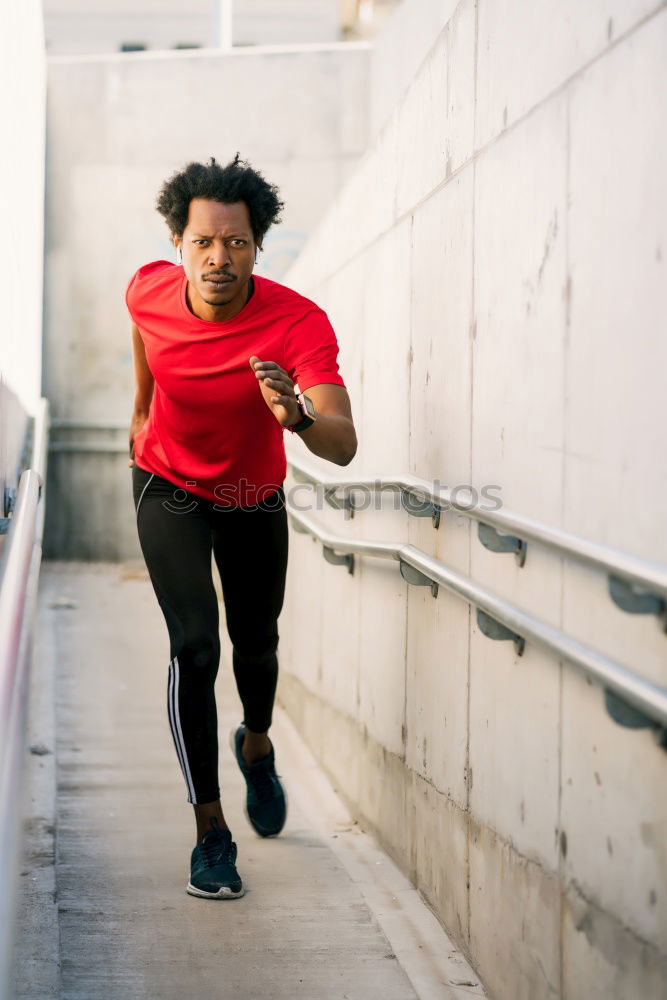 Similar – Image, Stock Photo Black man running upstairs outdoors listening to music with white headphones.