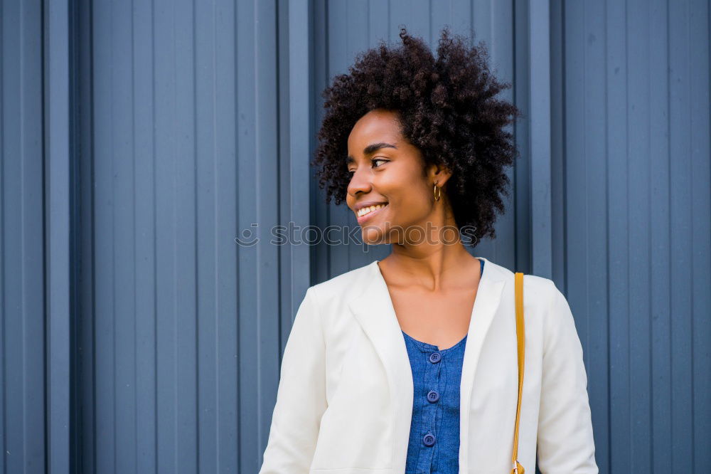 Similar – Image, Stock Photo Portrait of a cheerful young african woman standing outdoors