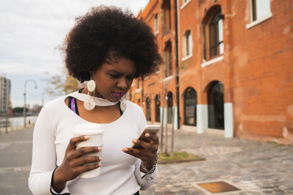 Similar – Happy woman with hat in city street, while using technology