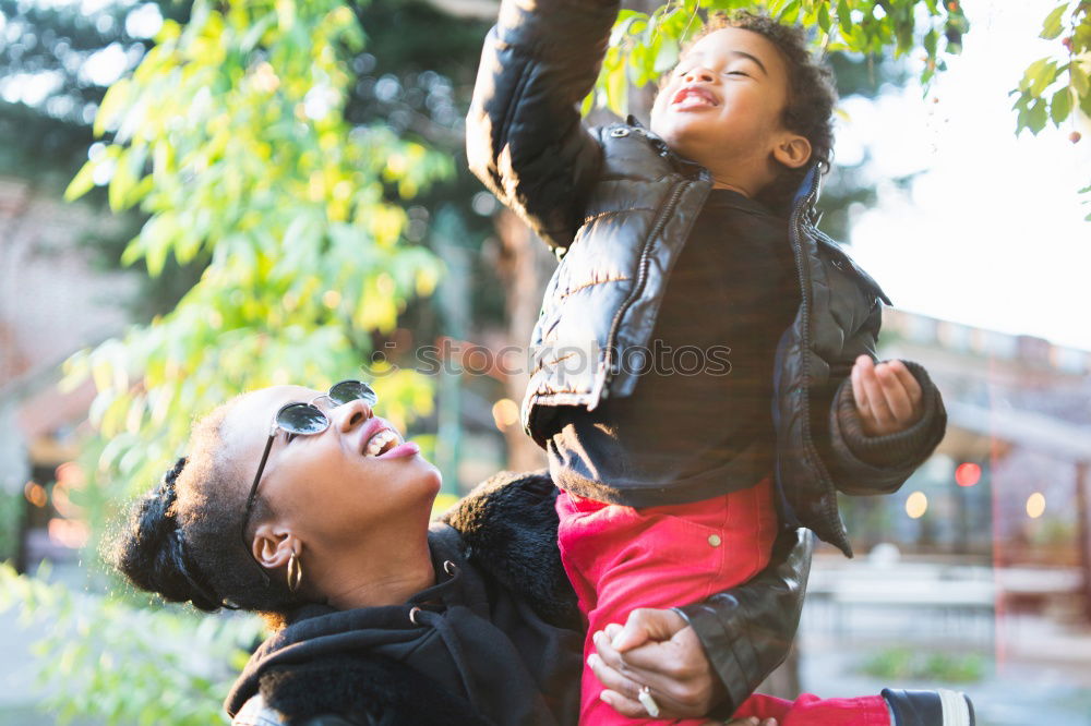 Similar – Black father feeds his son a kiwi