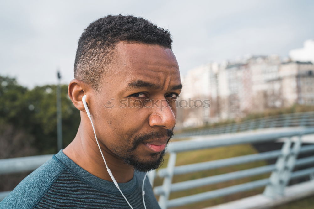 Similar – Handsome afro-american man biting his lip and looking aside in Gran via, Madrid.