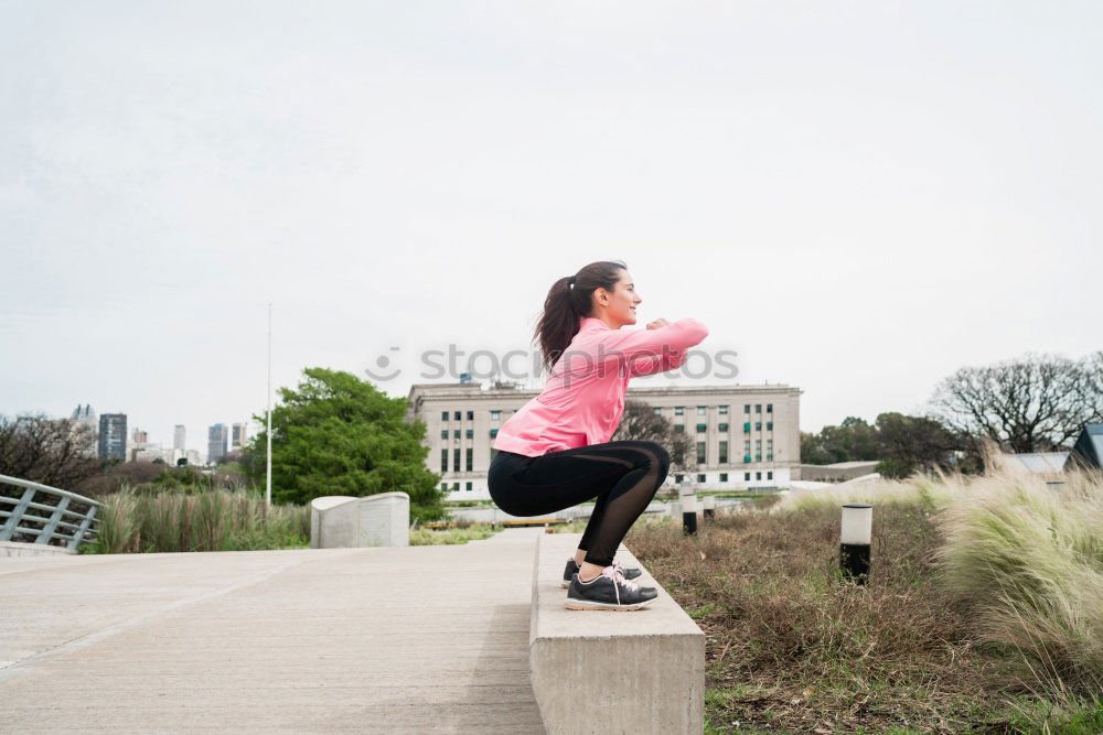 Similar – Woman tying hair in ponytail getting ready for run.