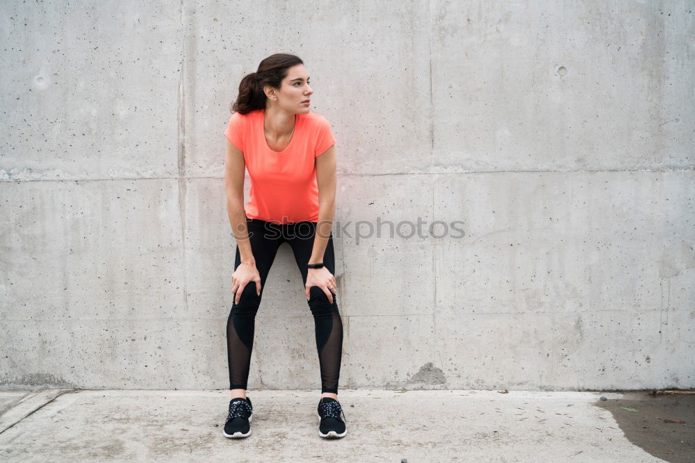 Young sporty woman doing exercises with a latex band