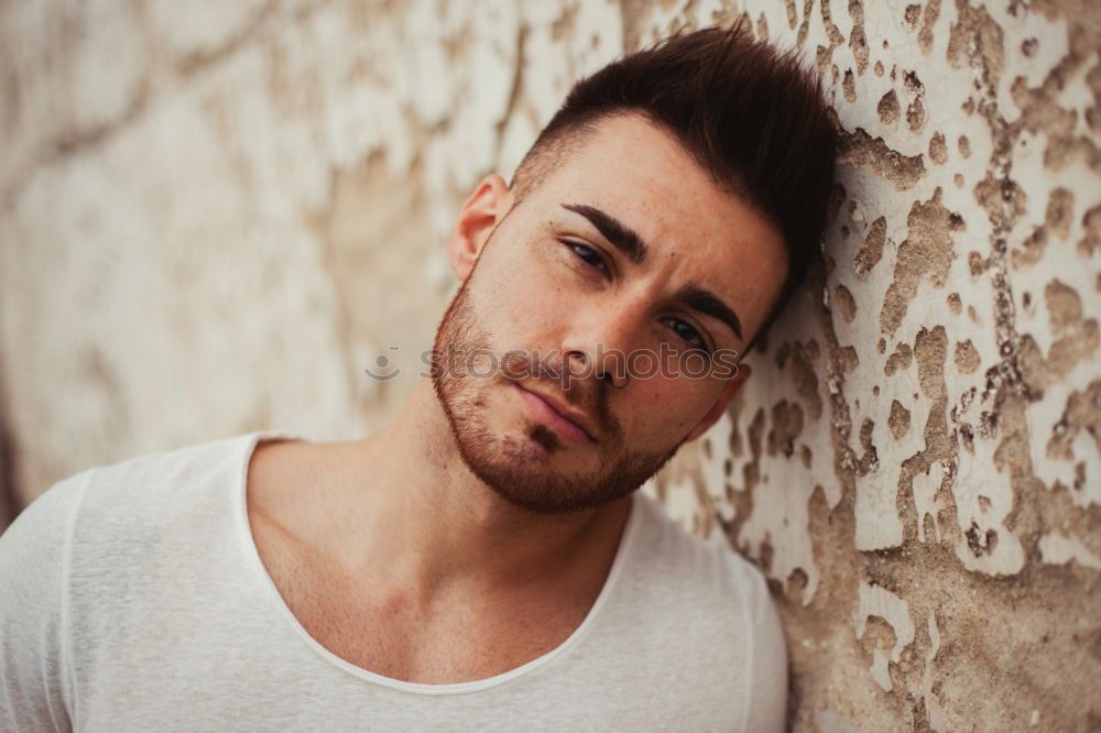 Similar – young handsome man with t-shirt against a wall in street