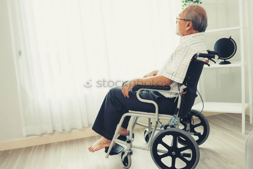 Similar – Senior woman sitting in wheelchair in hospital