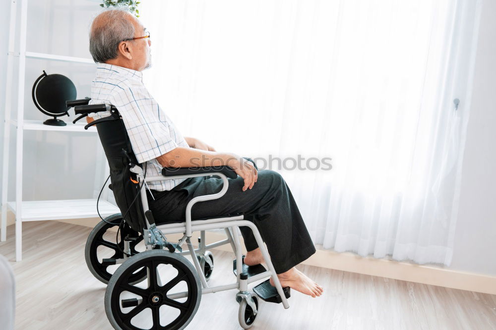 Similar – Senior woman sitting in wheelchair in hospital